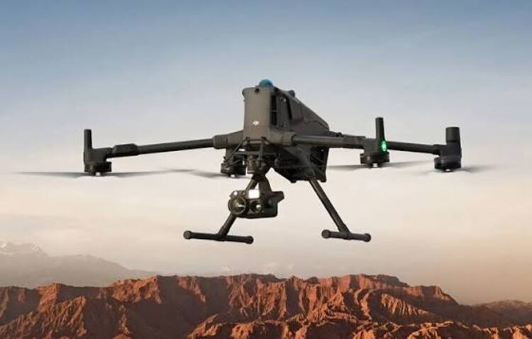 Survey drone in flight over rugged terrain